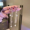 Detail of pink butterfly earrings featuring crystal wings and long pearl fringe tassels - Gold Bowknot (Silver Earring Post)