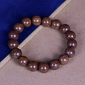 Deep brown 15mm Liu Dao Mu wooden bead bracelet with natural grain on blue background - Premium Old Wood 12mm*17 Beads (Classic Style)
