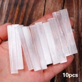 Set of 10 natural white selenite crystal sticks with fibrous texture held in hand - 10pcs Selenite Wands