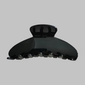 Detail view of large black acetate hair claw clip for elegant women styling - Black