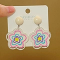 Detailed macro view of colorful acrylic flower earrings hanging on a white jewelry card - No.91 Acrylic Multi-Color Drop Earring (XXX6731)