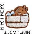 Dettaglio di una toppa ricamata a forma di orso bruno con misure 3,5 cm x 3,4 cm - Orso in Vasca/Torta