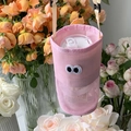 Pink mesh water bottle carrier with cartoon eyes and adjustable beige crossbody strap - Pink
