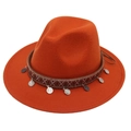 Close-up of bohemian felt fedora with ethnic woven band and silver metal pendants - Caramel color