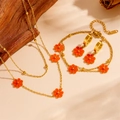 Golden stainless steel jewelry set featuring orange daisies with necklace, bracelet and earrings - Red Shell Set (L505-L707-L503)