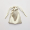 Elegant champagne satin drawstring gift bag with smooth silk texture on white background - Apricot