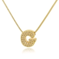 Detail of gold letter G pendant necklace with pavé cubic zirconia on box chain - Letter G