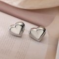Polished silver heart stud earrings shown on a vintage book for a minimalist look - Silver Smooth 3D Heart