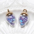 Detailed view of water drop glass pendants filled with purple iridescent star sequins on ceramic - Water Drop / Purple