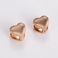 Detailed view of heart-shaped rose gold earrings with stylish vertical striped texture - Rose Gold