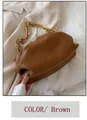 Brown matte leather cloud handbag with chunky gold chain strap held by hand - Brown