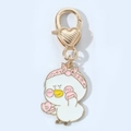 Detailed close-up of a cartoon duck keychain with pink headband and heart-shaped clasp - Pink Hat Duck