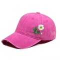 Rose pink washed cotton baseball cap with daisy floral embroidery in a 45-degree side view - One Size / Rose Red