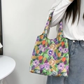 Detailed shoulder view of floral canvas tote bag with oil painting style pattern print - Purple and Green Flowers