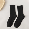 Single pair of black cotton crew socks with vertical stripe texture on beige linen background - Knee High / Black