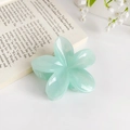Mint green plumeria flower hair claw clip in a glossy resin finish for elegant styling - Cyan