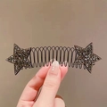 Close-up of black metal hair comb with sparkling rhinestone star-shaped decorations - Black Star Spring Comb