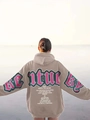 Detail of the oversized taupe hoodie featuring white vintage artistic back lettering - S / Camel