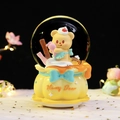 Snow globe with yellow honey bear and blue bow on a yellow base carousel music box - 8523 Piping Cream / Medium 80mm Light + Music