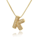 Macro shot of gold plated letter K pendant necklace with micro-paved white zircon details - Letter K