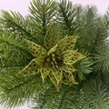 Glittering gold hollowed-out Christmas flower ornament placed on green pine needles - Army Green