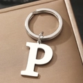 Letter P metal keychain pendant with ring displayed on a brown leather gift box - Letter P