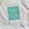 Mint green floral storage pouch with crinkled fabric and white snap button closure - Green Yellow Floral