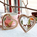 Hollow heart-shaped wooden Christmas ornaments featuring deer and pine tree designs - Heart Charm