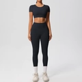 Front view of black nylon fitness set featuring cropped short sleeve top and high waist leggings - S / Black