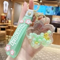 Green liquid quicksand keychain with flower charm and Happy Day silicone strap - Pearl Sakura - Green