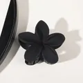 Macro shot of matte black flower hair claw with five petals and metal spring mechanism - Matte Black