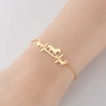 Pulsera dorada de acero inoxidable con caballo y latido de corazón en muñeca mujer - Dorado