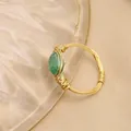 Handcrafted gold wire wrapped ring featuring a natural oval green jade stone - US 6