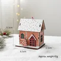 Illuminated wooden gingerbread house ornament with snowy roof and festive pine decor - Gingerbread House With Christmas Tree