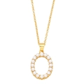 Macro detail of golden oval pendant with delicate inlaid white pearls on the edge - Letter O