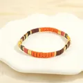 Detail of colorful bohemian enamel tiles and golden beads on an elastic bracelet - Yellow Brown Multicolor-F
