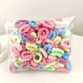 Macro view of colorful elastic cotton hair ties with soft knitted texture in a large pack - Floral Spring