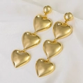 Exaggerated gold heart dangle earrings with three smooth heart pendants on silk - Golden Triple Heart Long Drop Earrings