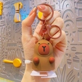 Brown Capybara keychain with mechanical wind-up knob and lobster clasp for bags - Wind-up Capybara - Brown White