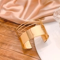Elegant gold open cuff bracelet with layered filigree design on pink silk background - Gold Multi-layer Geometric