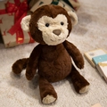 Plush monkey toy in brown and beige with a festive gift box on a white soft carpet - 30cm / Monkey