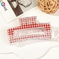 Pink checkered hair claw clip with white heart patterns shown on a magazine backdrop - 8.5cm Heart Print - Style H Transparent Base