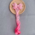 Detail of pink gradient curly hairpiece with a large glittery sequin bow on a tray - Light Pink Gradient Rose Red