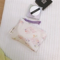Detail of floral mini cotton pouch with purple cord zipper and brand label on soft padding - Pink Sakura