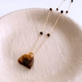 Macro detail of a golden handbag pendant with brown tiger eye stone on a beaded chain - Gold Necklace-Brown Tiger Eye Bag Pendant