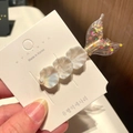 Close-up of shell hair clip with iridescent fishtail and pearl details on white card - 9# Mermaid - Pink