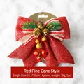Christmas bow decoration with red sequins, pine cones and berries on snow background - Red Pine Cone Christmas Bow