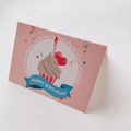 Close-up of pink folding birthday card with blue Happy Birthday banner on white backdrop - Happy Birthday Candle