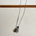Collier en pierre œil de tigre avec grappe de perles argentées sur tissu beige - Style B Collier Grappe de Raisin Goutte d'Eau Oeil de Tigre