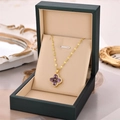 Golden clover necklace with violet drop-shaped stones in an elegant green jewelry box - Gold Purple